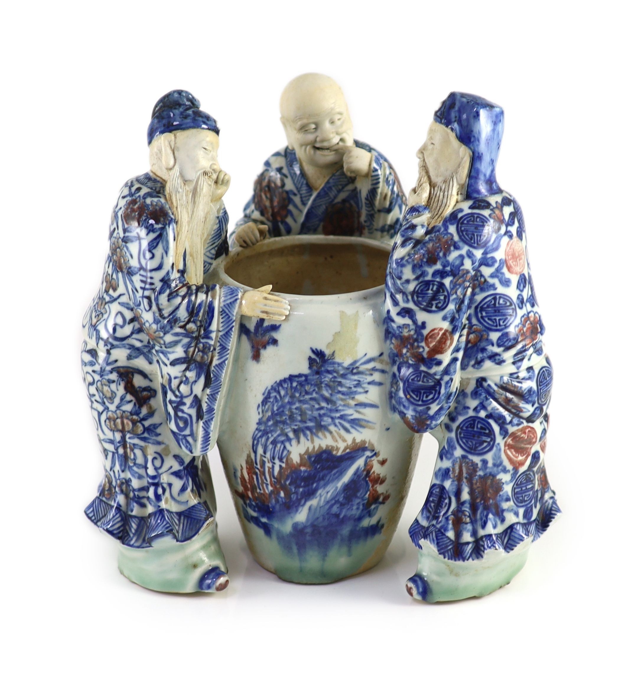 A rare Chinese underglaze blue and copper red porcelain model of the ‘Vinegar Tasters’, Qing dynasty, 26.cm high